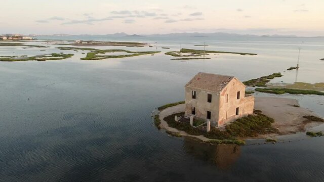 House isolated by water in mediterranean sea drone view. Lonely house in island surrounded by water as a consecuence of sea level growth due to melt down of polar ice, defrostation. 
