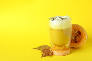 Concept of pumpkin latte on yellow background