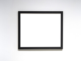 Photo frame mockup, black frame with white blank sheet on the wall. Space for text.