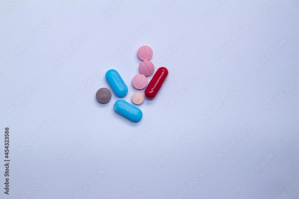 Wall mural Colored pills on a white background. Medicines or legal drugs for human consumption.