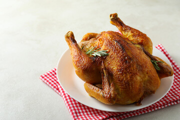 Plate with roast turkey on white textured table