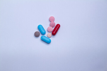 Colored pills on a white background. Medicines or legal drugs for human consumption.
