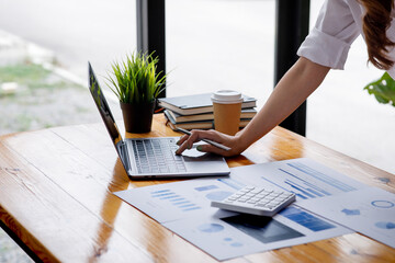 Close up of Business woman accountant or financial expert analyze business report graph and finance chart at corporate office. Concept of finance economy, banking business and stock market research. 