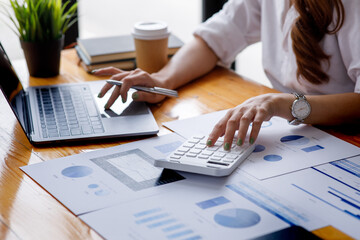 Close up of Business woman accountant or financial expert analyze business report graph and finance chart at corporate office. Concept of finance economy, banking business and stock market research. 