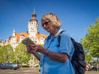 Portrait of a senior woman tourist with map