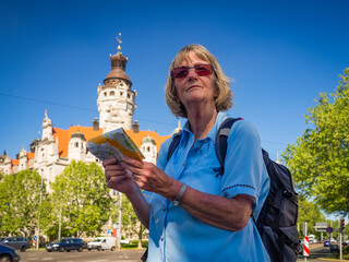 Portrait of a senior woman tourist with map