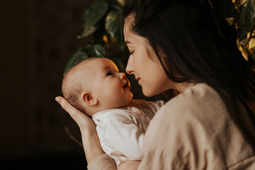 Portrait of happy baby in mother's arms