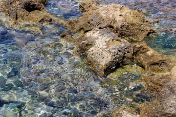 background of beautiful photography of the rocky coast of the clear blue sea