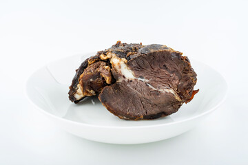 Piece of beef with sauce on white background