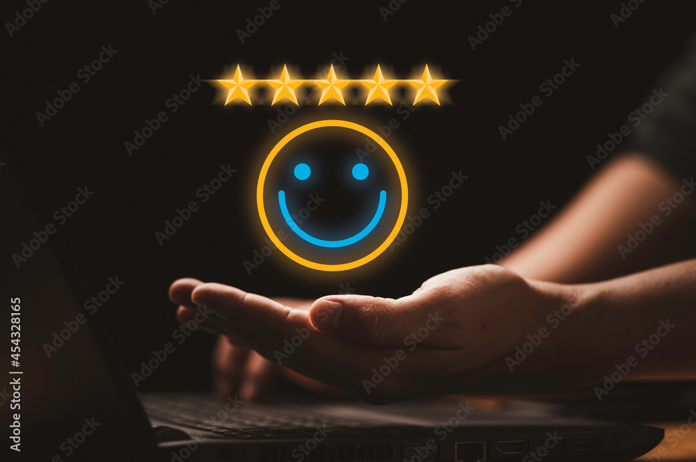 Poster businessman holding virtual smiley face with five stars and using computer laptop for online evaluat