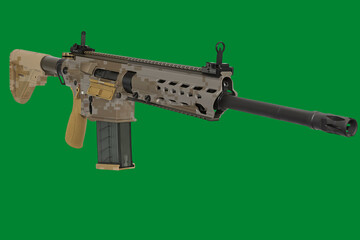 modern automatic rifle in camouflage livery. a photograph of a weapon on a chroma key.