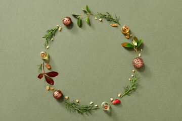 Christmas background with essential oils, frankincense, wintergreen and thuja on green background