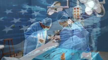 Animation of flag of usa waving over surgeons in operating theatre - Powered by Adobe