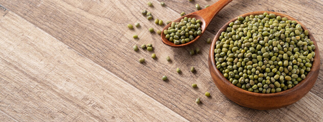 Close up of raw mung bean on wooden table background.