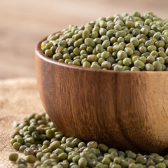 Close up of raw mung bean on wooden table background.