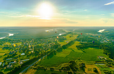Aerial landscape view with colorful hot air balloons
