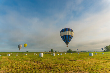 Obraz premium hot air balloons over rural landscape