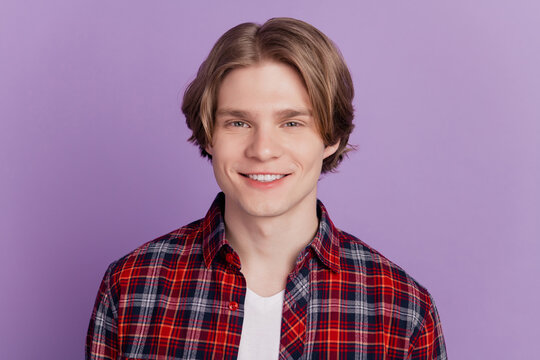 Portrait of cheerful charming positive guy toothy beaming smile posing on violet background