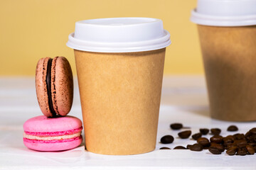 Coffee to go in paper eco cup with french macaroon on wooden and light orange background, Fast food, Copyspace, Caffeine Drink take away, Bean