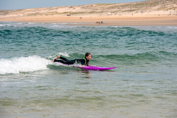 Fototapeta na wymiar cute young girl learning to surf