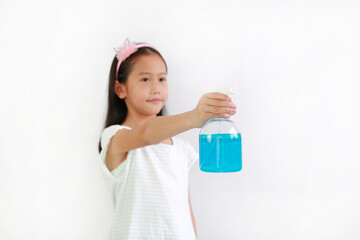Asian girl kid using bottle spray alcohol liquid for against coronavirus pandemic outbreak on white background, antiseptic. Selective focus at kid hand and alcohol bottle
