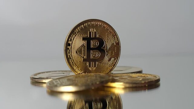 Cryptocurrency, bitcoin. BTC, Bitcoin. Blockchain technology, bitcoin mining. Macro shot of rotating bitcoins on white uniform background