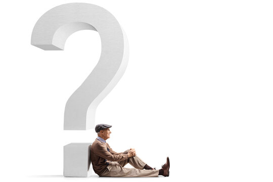 Elderly man sitting on the floor and leaning on a big question mark