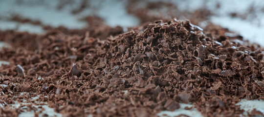 Grated chocolate close-up. The blank for the cake. The background in blur.