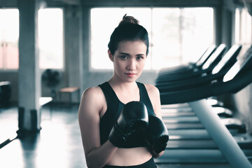 Female Boxer is Training Punch Boxing in Fitness Gym, Portrait of Sport Boxer Woman in Sportswear Exercised Practicing Boxing in Gym Club. Exercising Lifestyles and Fitness Sport Workout Training