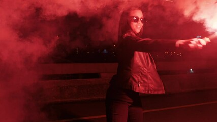 woman dancing with flare in city at night rebellious girl protesting in street with firework female millennial freedom movement