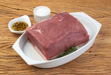 Raw ancho beef, typical argentinian cut, over white plate with seasonings