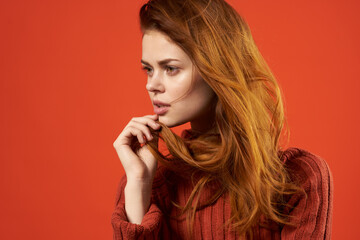 red-haired woman in red sweater fashion studio posing
