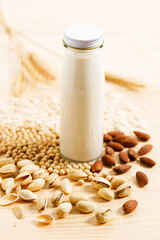 substitute milk in bottle on wooden table.