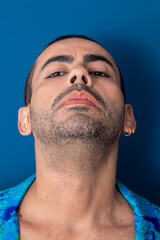 Obraz premium gay man colored nails with rainbow, freedom, no prejudice, beautiful nails, blue and green suit on blue background