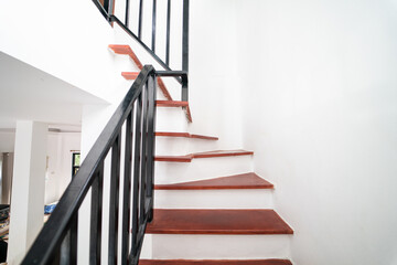 Red brown wooden stair in modern white new house