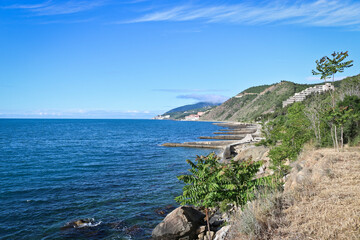 Black Sea coast with dilapidated breakwaters. Abandoned resort. Beautiful blue sea.