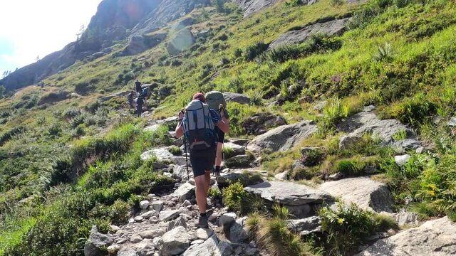 Lac Blanc hiking. Hikers reach Lac Blancs in Chamonix France.  One of the most popular destination for hikers in Chamonix