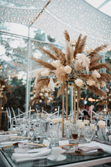Vertical shot of the classy and elegant tables of an outdoors wedding reception