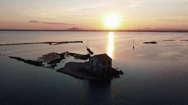 House isolated by water in mediterranean sea drone view. Lonely house in island surrounded by water as a consecuence of sea level growth due to melt down of polar ice, defrostation. 