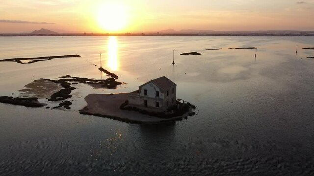 House isolated by water in mediterranean sea drone view. Lonely house in island surrounded by water as a consecuence of sea level growth due to melt down of polar ice, defrostation. 
