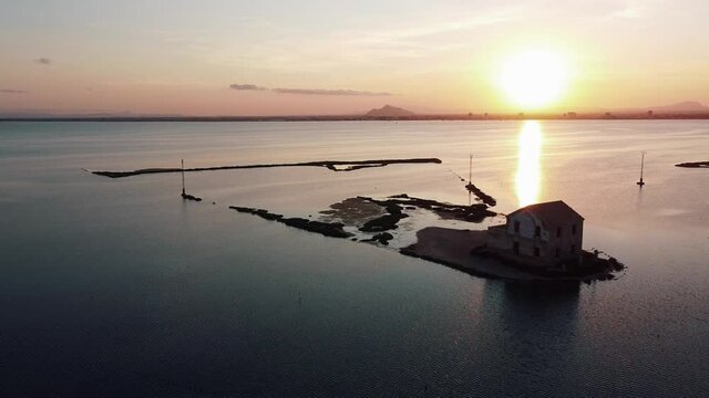 House isolated by water in mediterranean sea drone view. Lonely house in island surrounded by water as a consecuence of sea level growth due to melt down of polar ice, defrostation. 