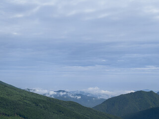 Naklejka premium clouds over the mountains in the morning