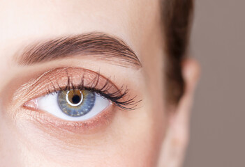 Obraz premium A blue eye beautiful young woman close-up, vision concept.