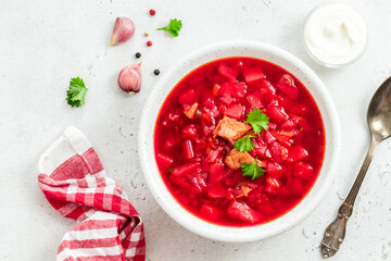 Red beetroot vegetable soup, borscht on light background. Top view, copy space.