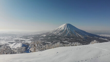 Fototapeta na wymiar Mount Fuji in Japan in winter. A volcano covered with snow. Snow mountain from afar