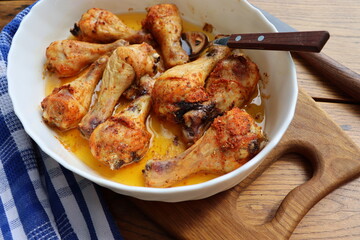 Roasted chicken legs with herbs in the pan