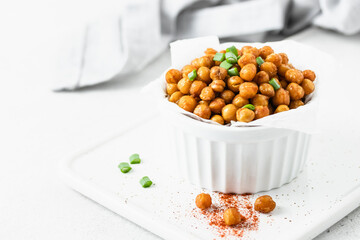 Baked smoked paprika spicy chickpea in a bowl. Space for text.