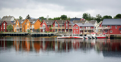 Fototapeta premium Typical Rourbuer fishing cabins in Lofoten village on a rainy day, summertime