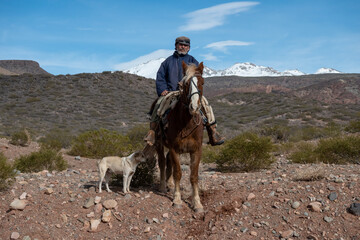  Argentine cowboy (gaucho) walks his horse past camera, in Patagonia.in Patagonia.