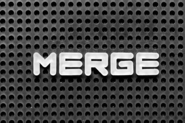 White alphabet letter in word merge on black pegboard background